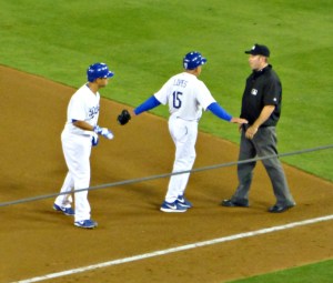 1b coach Davey Lopes keeps Hairston away from the ump who's eyesight remains in ???